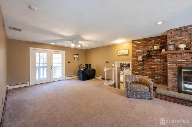 a view of a livingroom with furniture and a ceiling fan
