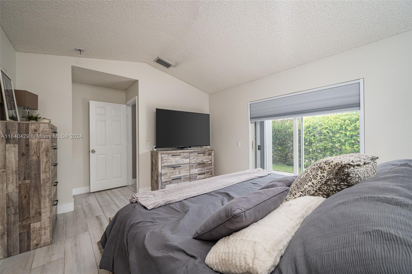 The Ridges Weston, FL 33331 - Photo 12 of 27 a bedroom with a bed and a flat screen tv