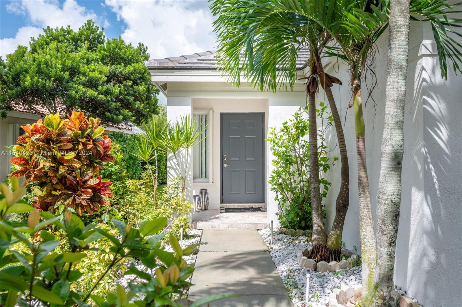 The Ridges Weston, FL 33331 - Photo 2 of 27 a front view of a house with a garden