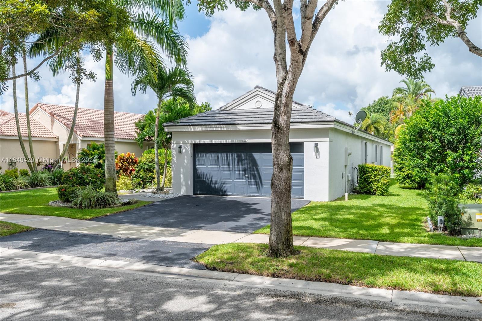 The Ridges Weston, FL 33331 - Photo 22 of 27 a front view of a house with a garden and trees