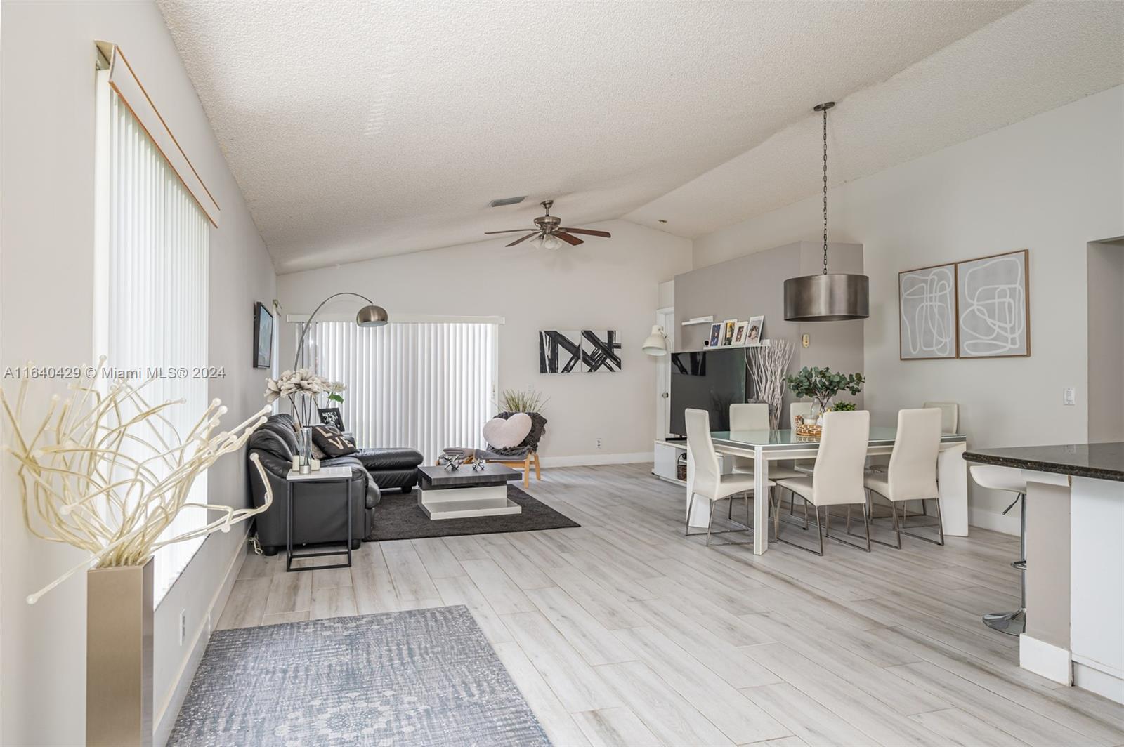 The Ridges Weston, FL 33331 - Photo 4 of 27 a living room with furniture a wooden floor and a fireplace