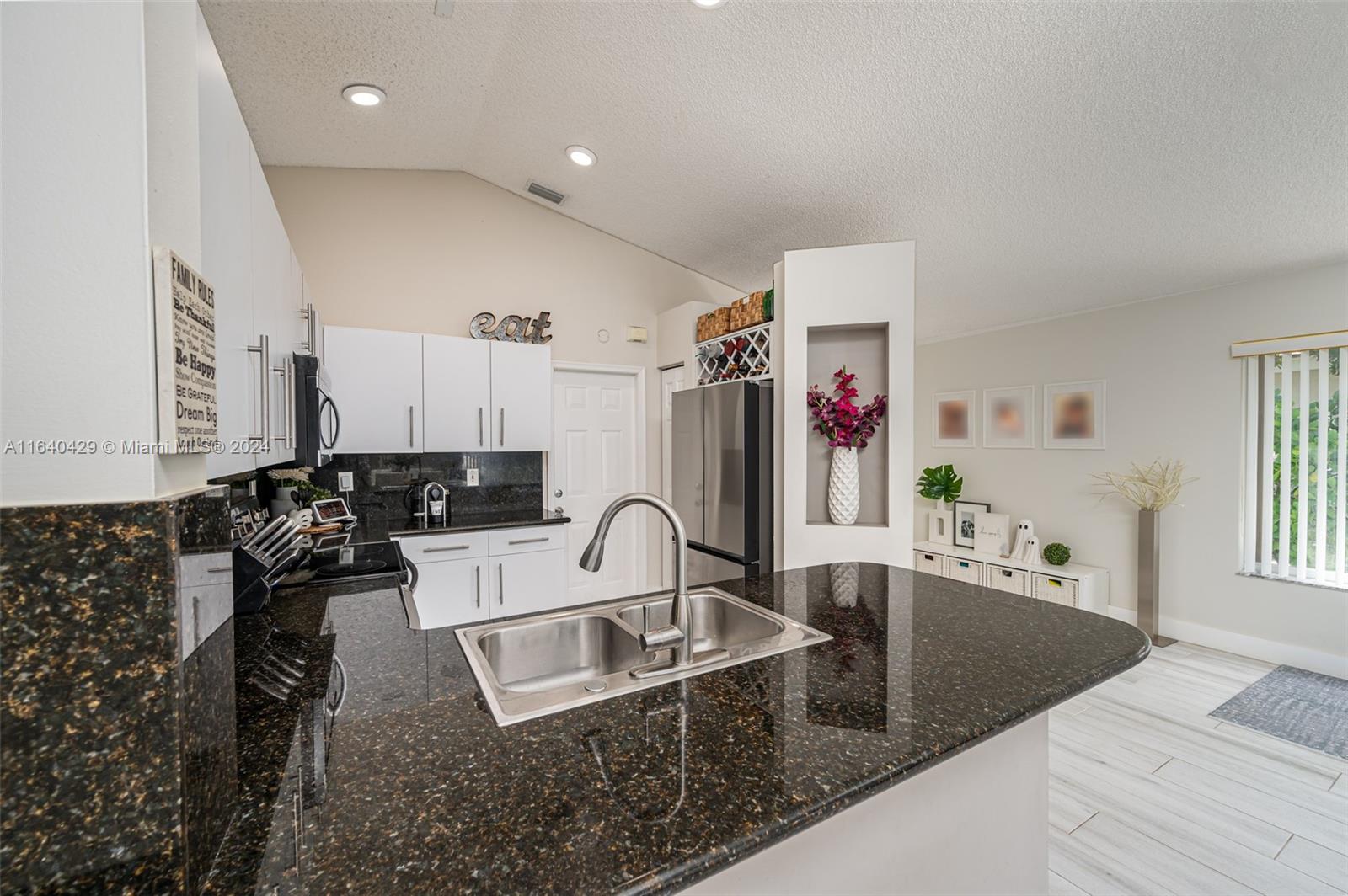The Ridges Weston, FL 33331 - Photo 8 of 27 a kitchen with granite countertop a sink and a stove top oven