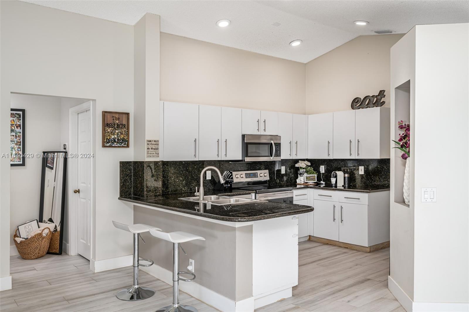 The Ridges Weston, FL 33331 - Photo 9 of 27 a kitchen with stainless steel appliances granite countertop a sink a stove a refrigerator and cabinets