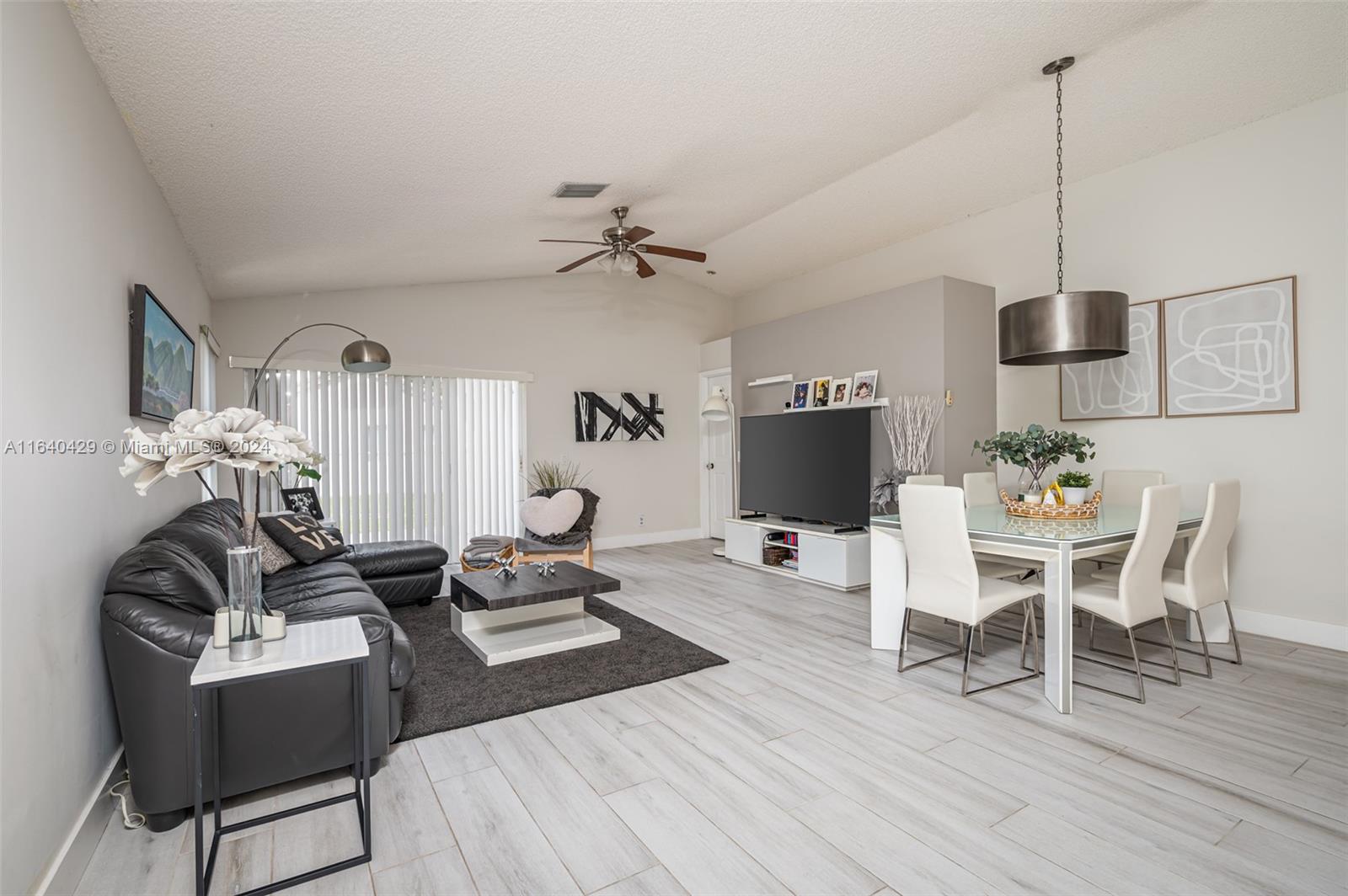 The Ridges Weston, FL 33331 - Photo 10 of 27 a living room with furniture a flat screen tv and a dining table