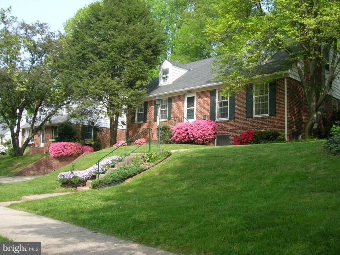 7103 Wardman Road Baltimore, MD 21212 - Photo 1 of 19 a front view of house with yard and green space