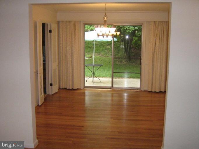 7103 Wardman Road Baltimore, MD 21212 - Photo 7 of 19 a view of a room with window wooden floor and front door