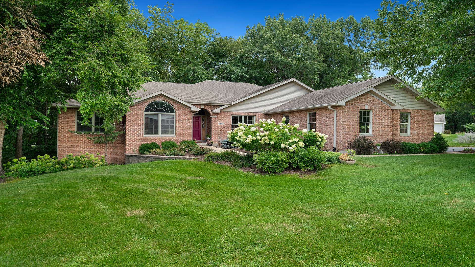 a front view of a house with a garden