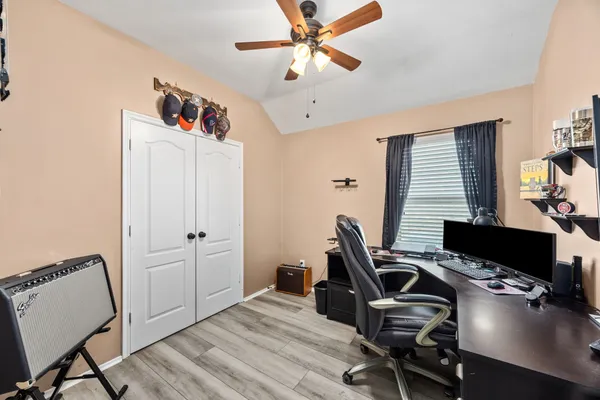 a view of a workspace with furniture and wooden floor