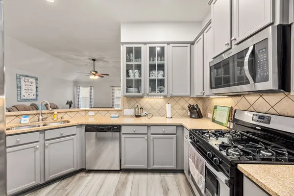 a kitchen with a sink stove and microwave
