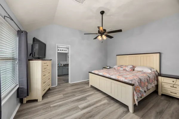 a bedroom with a bed and a flat tv screen