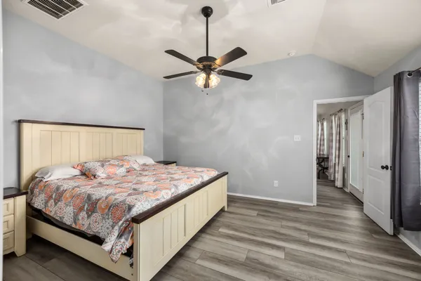 a bedroom with a bed and a chandelier