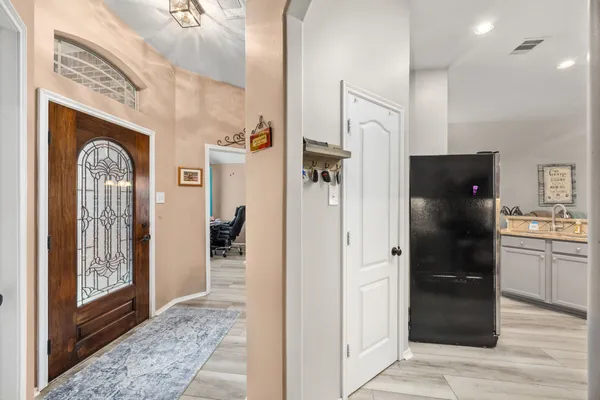 a bathroom with a glass door shower and a sink