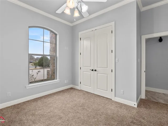 a view of an empty room with a mirror