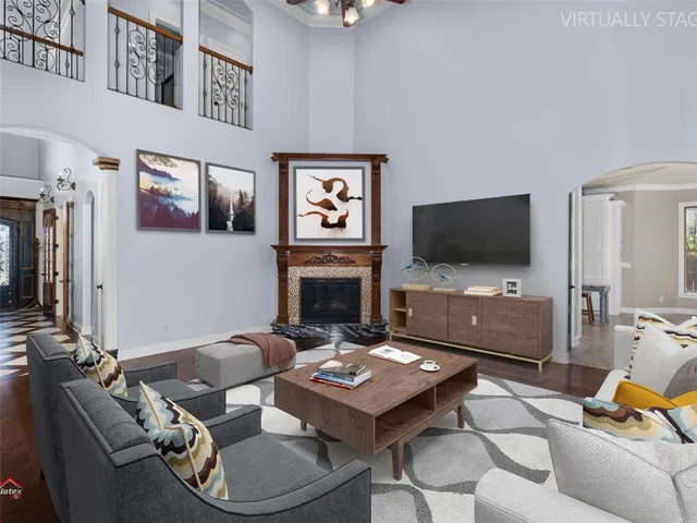 a view of an empty room with wooden floor fireplace and a window