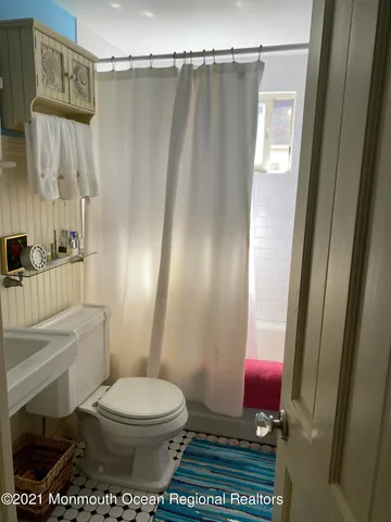 a bathroom with a toilet a sink and a shower