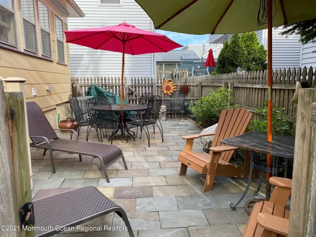 an outdoor space with patio and white umbrellas