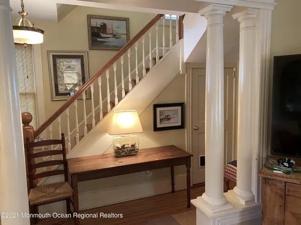 a view of entryway and hall with wooden floor