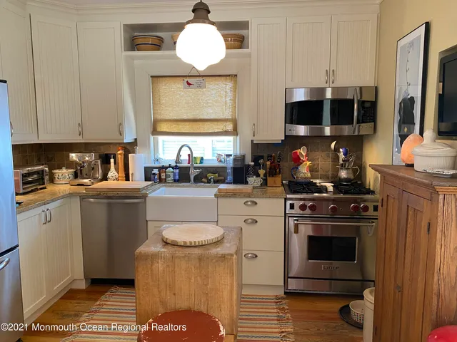 a kitchen with a stove oven and a sink