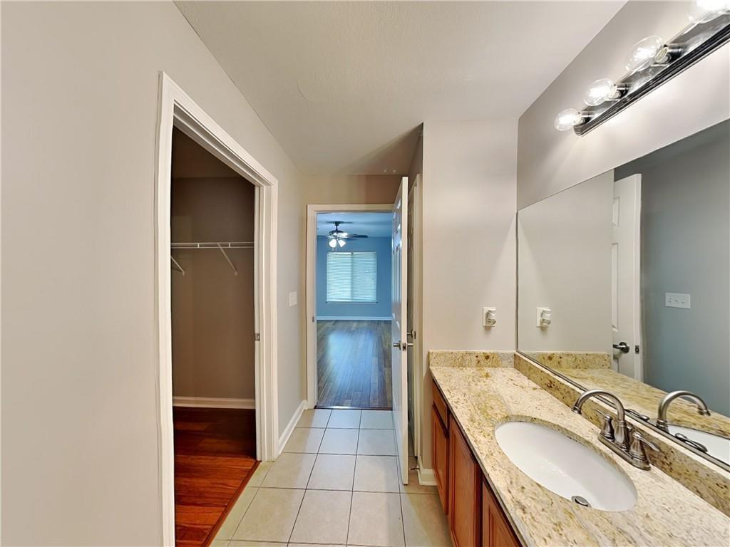 1020 Camelot Drive Atlanta, GA 30349 - Photo 11 of 17 a bathroom with a granite countertop sink and a mirror