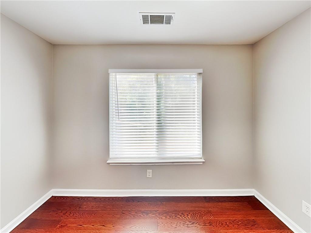 1020 Camelot Drive Atlanta, GA 30349 - Photo 13 of 17 an empty room with wooden floor and a window