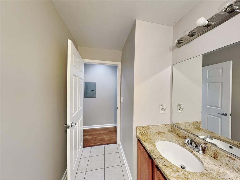 1020 Camelot Drive Atlanta, GA 30349 - Photo 15 of 17 a en suite bathroom with a granite countertop sink and a mirror
