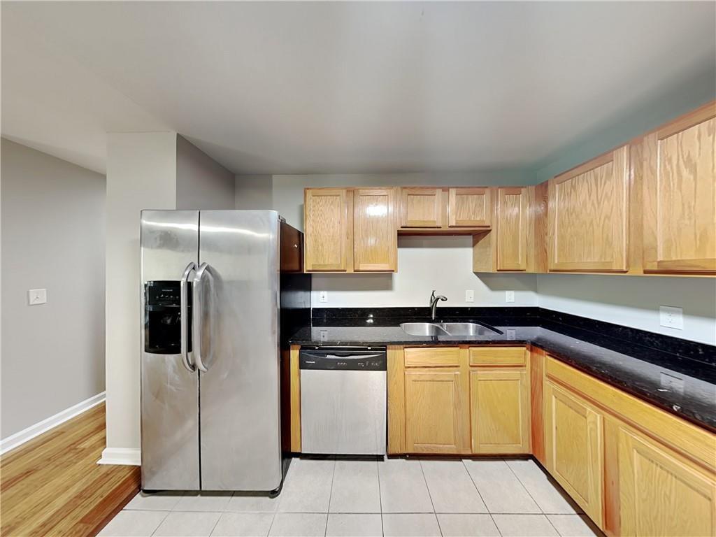 1020 Camelot Drive Atlanta, GA 30349 - Photo 4 of 17 a kitchen with a refrigerator sink and cabinets