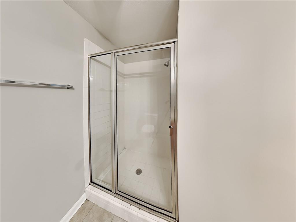 1020 Camelot Drive Atlanta, GA 30349 - Photo 10 of 17 a bathroom with a glass shower door