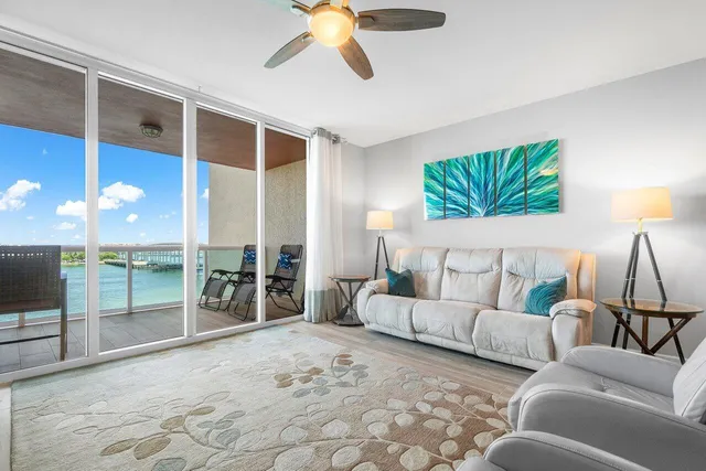 a living room with furniture and a floor to ceiling window