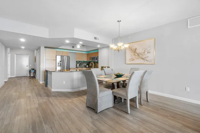 a kitchen with sink stove and cabinets with wooden floor