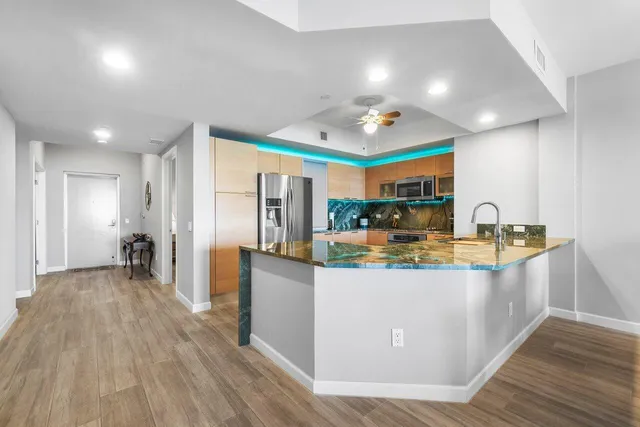 a kitchen with stainless steel appliances granite countertop a stove and a microwave