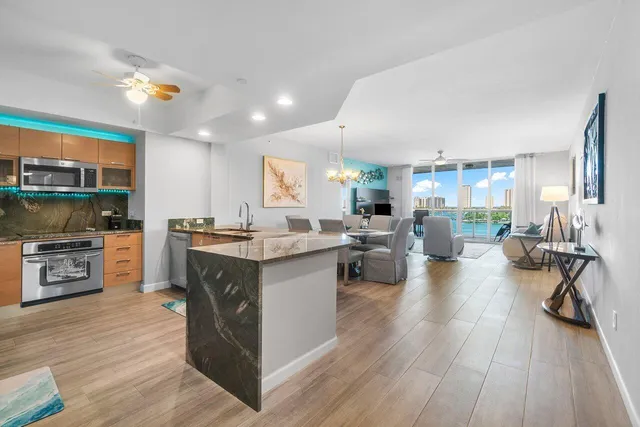 a kitchen with kitchen island granite countertop wooden cabinets and a stove