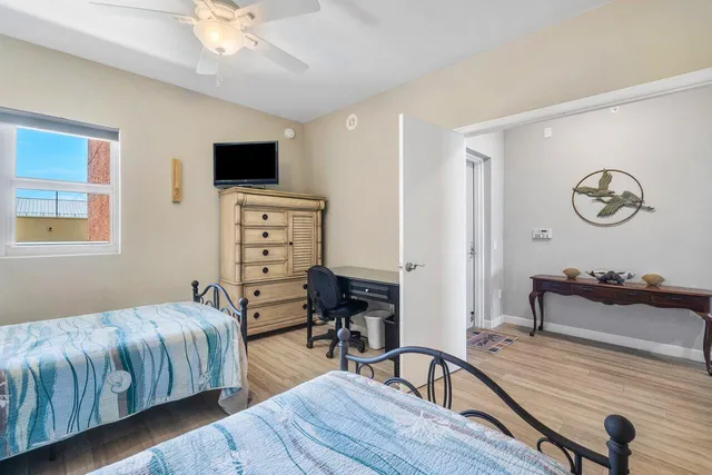 a bedroom with a bed and wooden floor