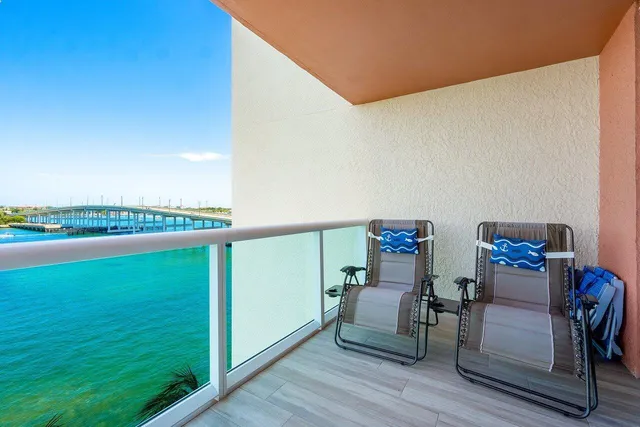 a view of a room with a floor to ceiling window and wooden floor