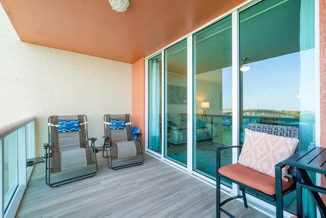a dining room with furniture a chandelier and wooden floor
