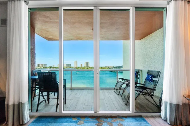 a living room with furniture a dining table and a chandelier