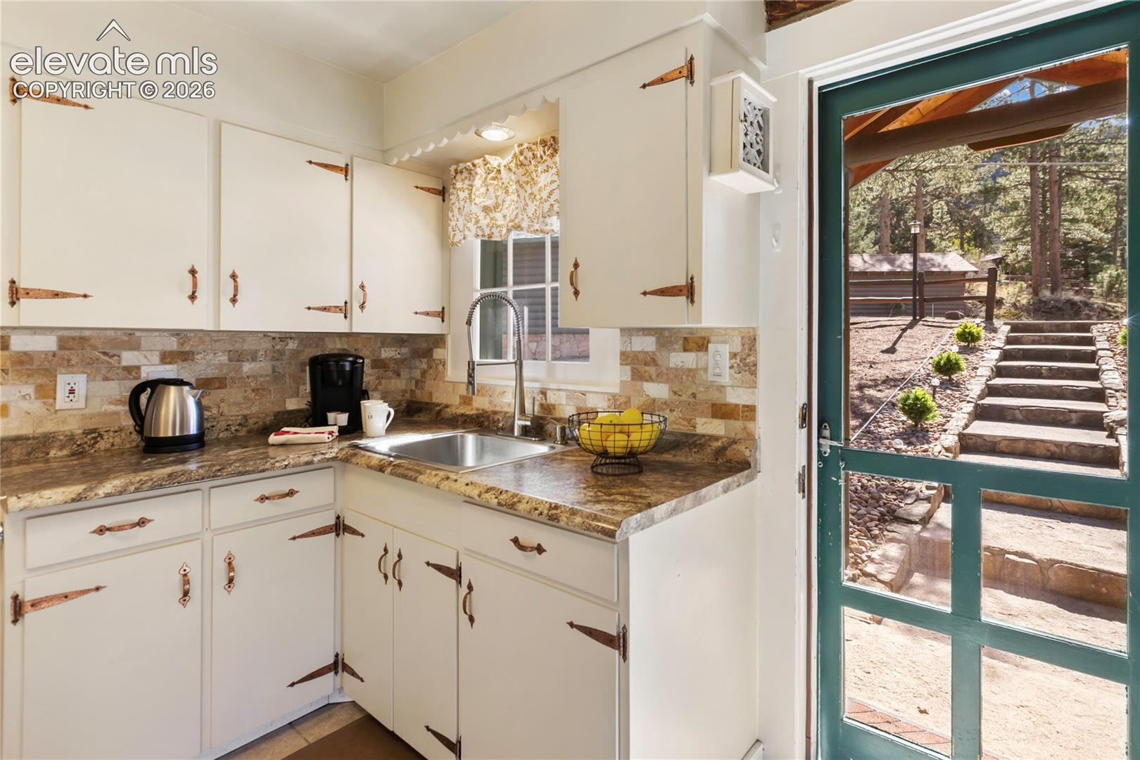 9120 Ute Road Cascade, CO 80809 - Photo 17 of 38 And a surprising amount of room in the kitchen with just the right touch of modern convenience meets historic charm!
