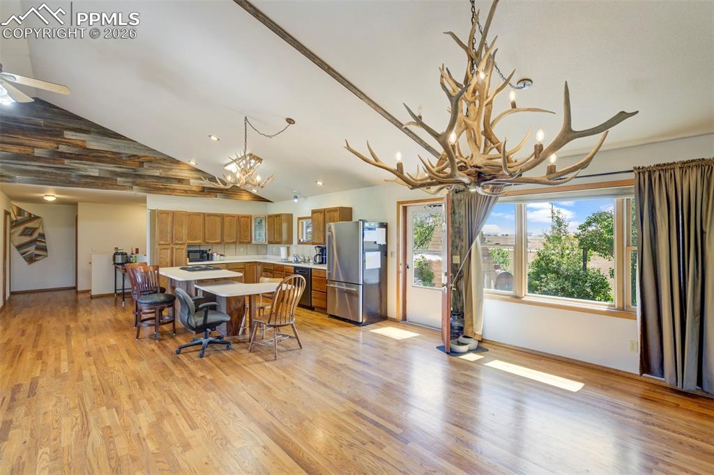 2550 Slocum Road Peyton, CO 80831 - Photo 16 of 49 a view of a dining room with furniture window and wooden floor