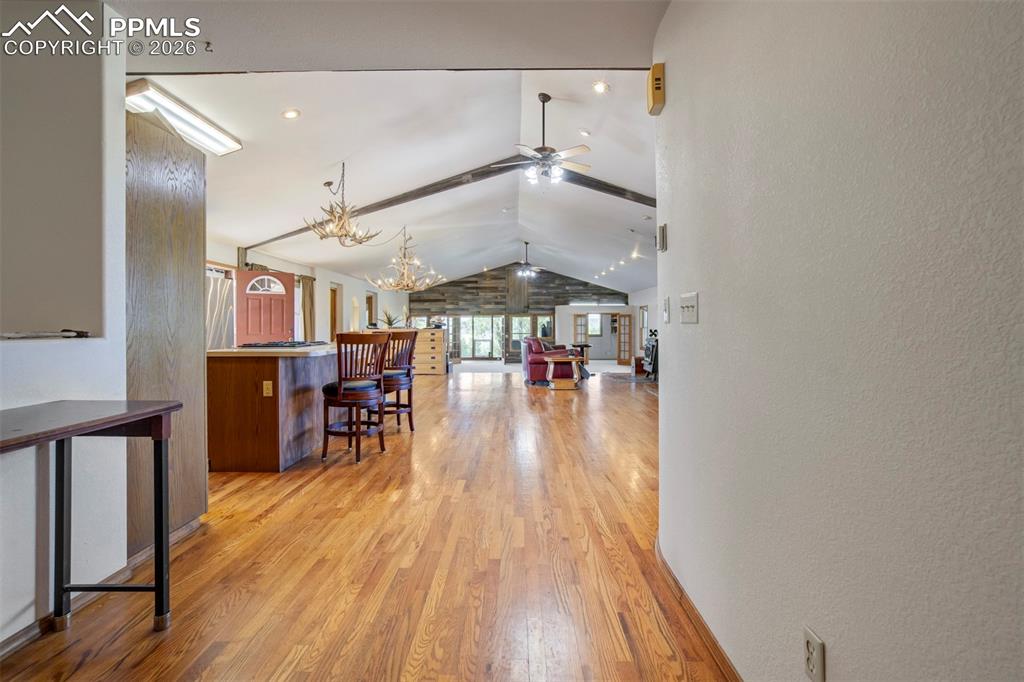 2550 Slocum Road Peyton, CO 80831 - Photo 19 of 49 a view of dinning room and livingroom with furniture wooden floor chandelier
