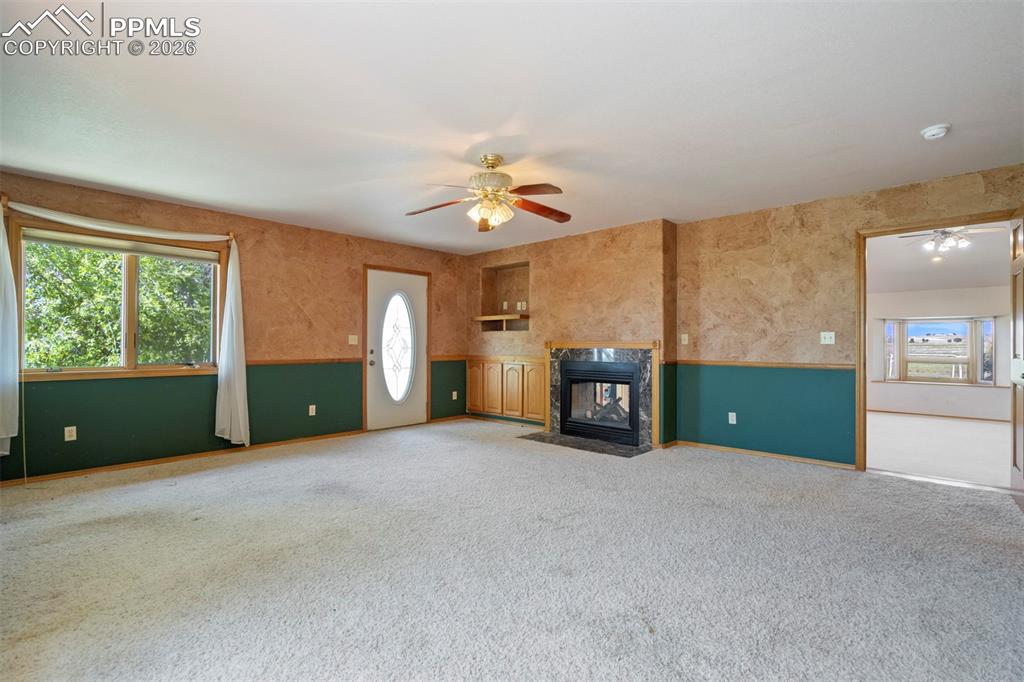 2550 Slocum Road Peyton, CO 80831 - Photo 21 of 49 a view of an empty room with a window and a kitchen