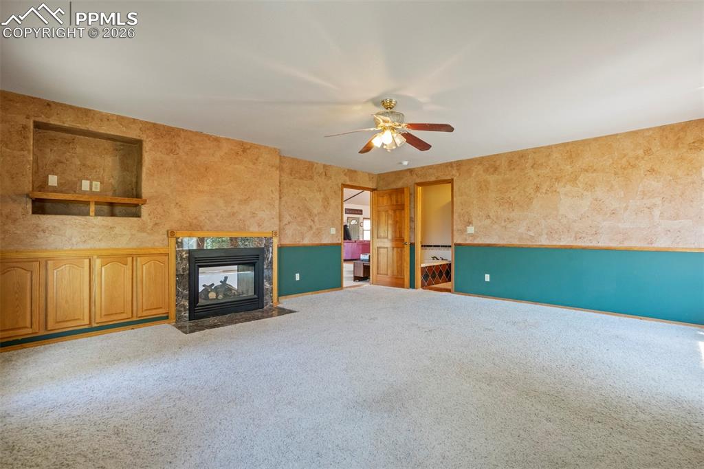 2550 Slocum Road Peyton, CO 80831 - Photo 23 of 49 a view of an empty room with a fireplace and a window