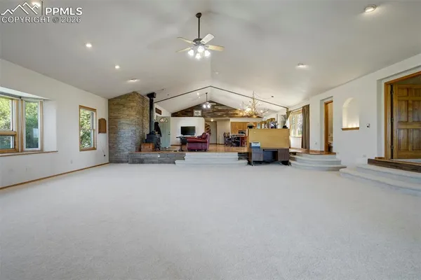 a view of dinning room and livingroom with furniture wooden floor chandelier