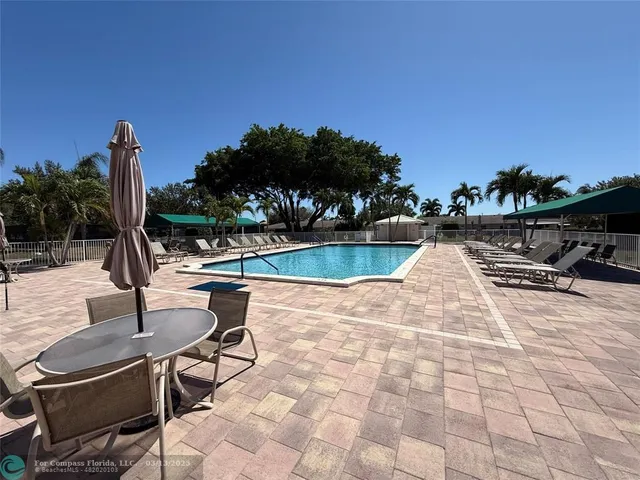 a view of a swimming pool with lounge chairs