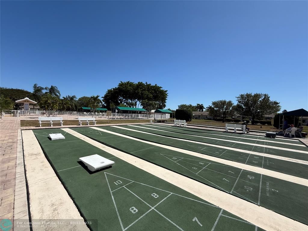 8540 Chevy Chase Drive, Unit 183 Boca Raton, FL 33433 - Photo 19 of 21 a view of a tennis court