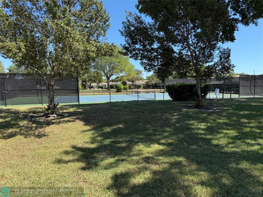 8540 Chevy Chase Drive, Unit 183 Boca Raton, FL 33433 - Photo 20 of 21 a view of a garden with trees