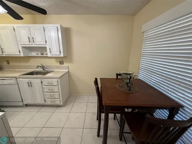 a kitchen with a sink cabinets and stove top oven