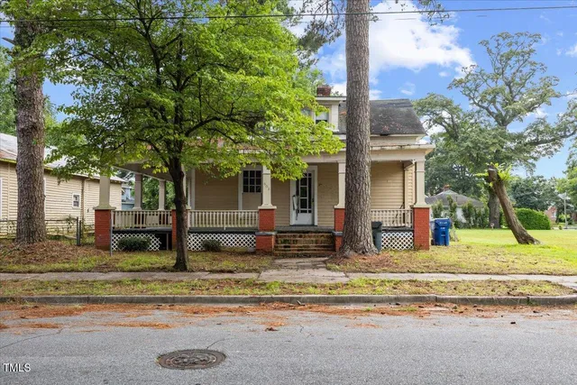 front view of a house with a tree in front of it