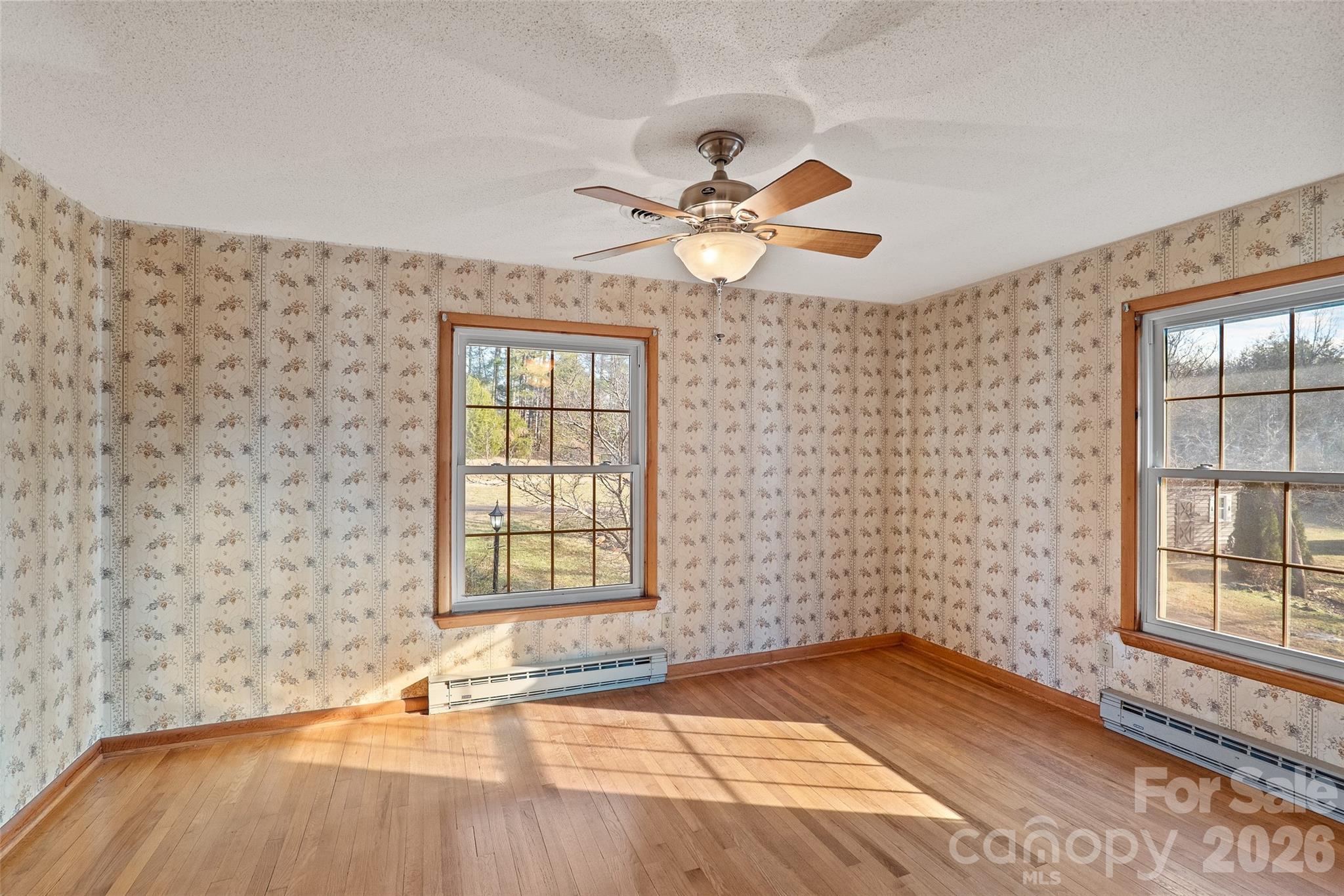 591 Landrum Road Tryon, NC 28782 - Photo 30 of 48 a view of an empty room with a window and wooden floor