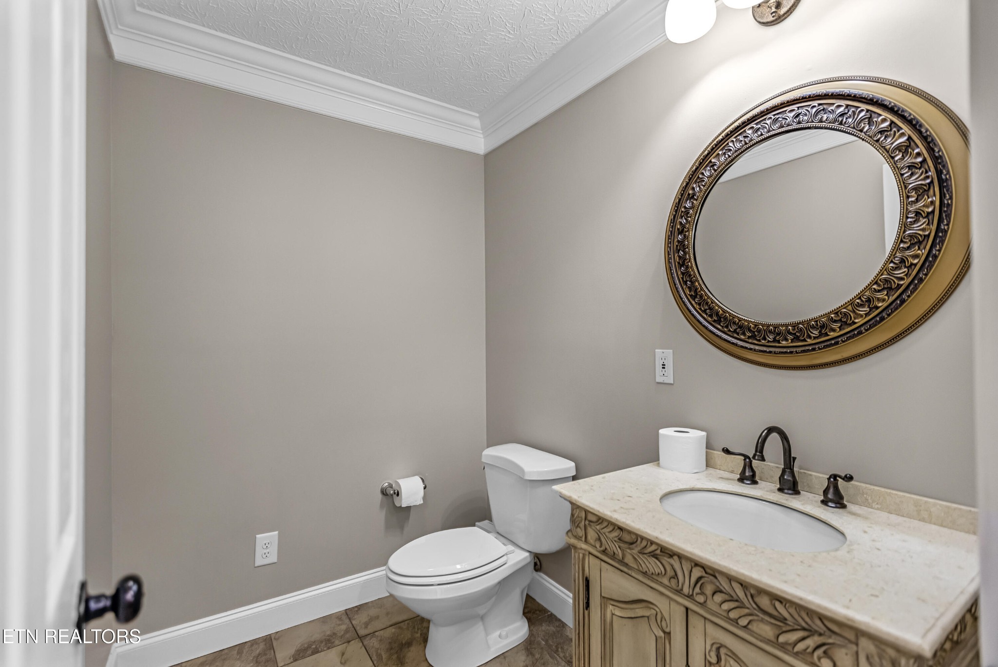 117 Mayview Drive Powell, TN 37849 - Photo 17 of 56 a bathroom with a granite countertop toilet a sink and a mirror