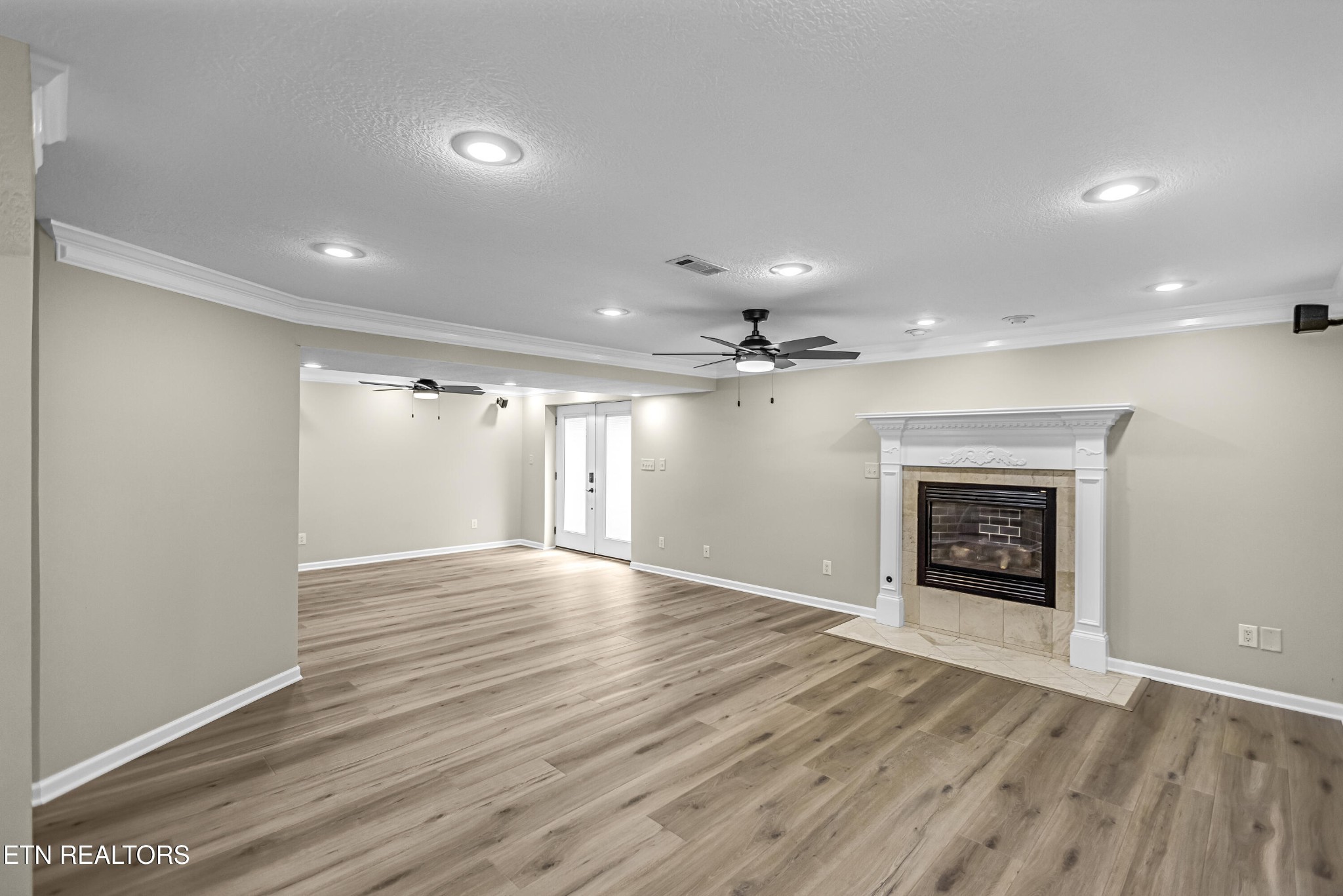 117 Mayview Drive Powell, TN 37849 - Photo 33 of 56 an empty room with wooden floor fireplace and windows