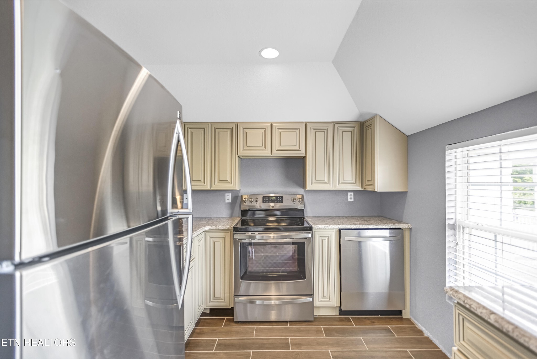 117 Mayview Drive Powell, TN 37849 - Photo 42 of 56 a kitchen with white cabinets and stainless steel appliances
